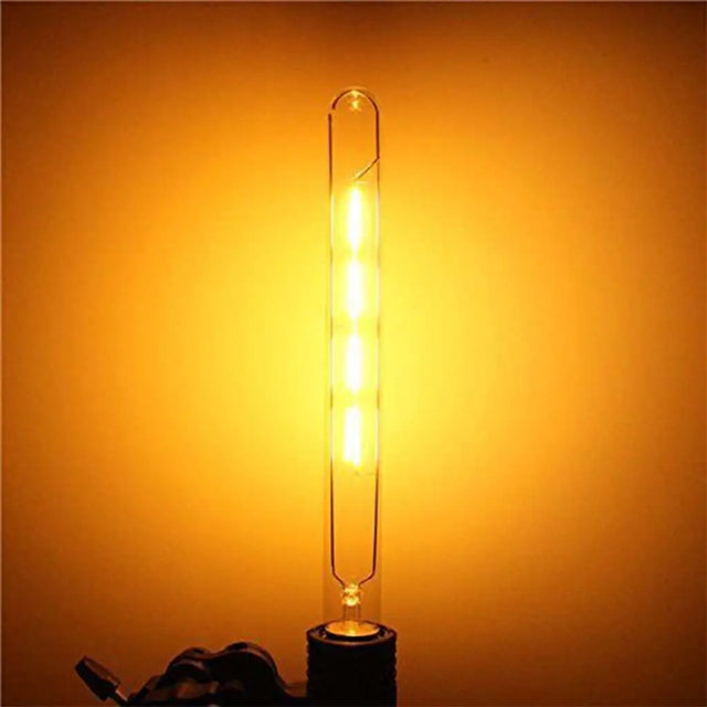 Tubular light bulb with a warm glow on an orange background