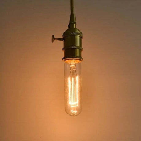 Vintage-style light bulb with a warm glow on a soft brown background