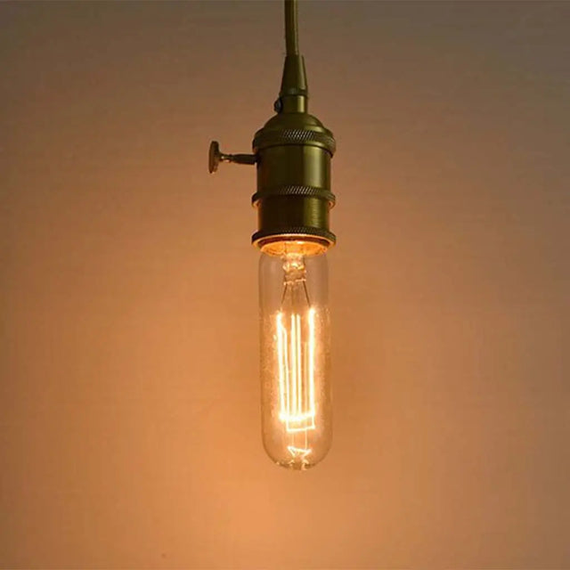 Vintage-style light bulb with a warm glow on a soft brown background