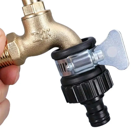 Gold faucet with black and silver connector held by a hand on a white background