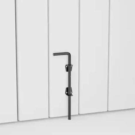 Black drop bolt against a white paneled wall