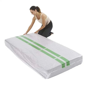Woman unrolling a white mattress protector with green stripes on a white background