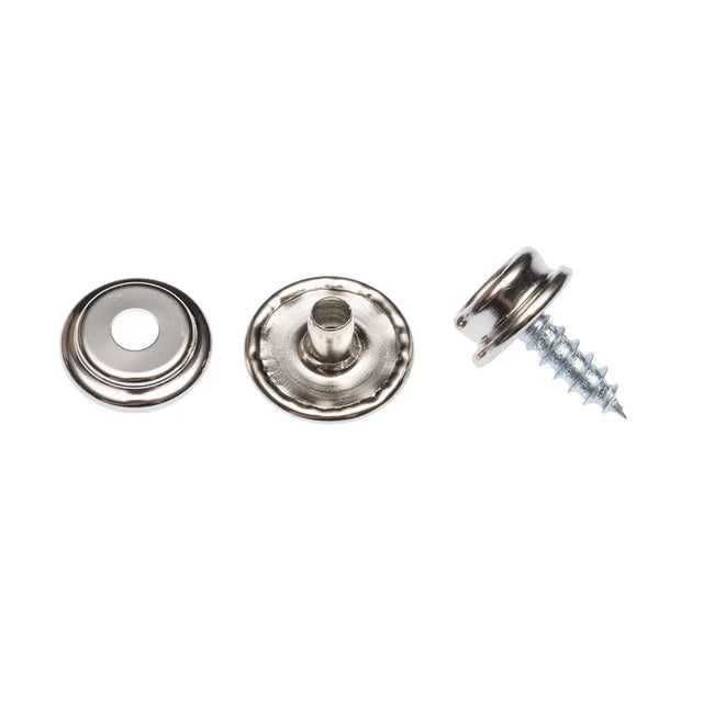 Metal snap buttons and a screw on a white background