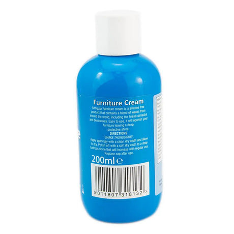 Blue bottle of furniture cream with a white cap on a white background