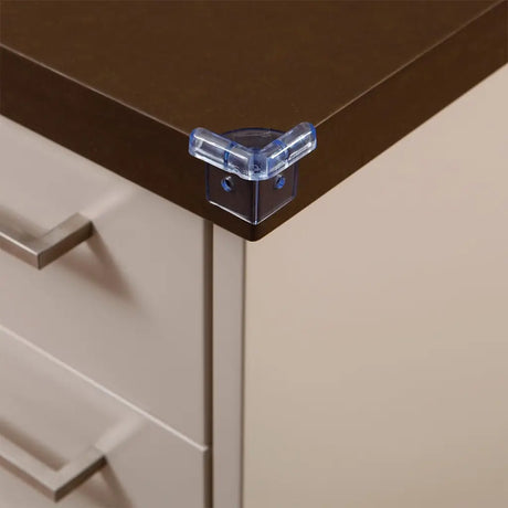 Clear corner protector on a brown cabinet corner