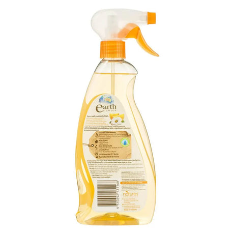 Clear spray bottle with orange nozzle and label on a white background