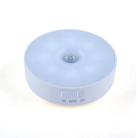 Round light fixture with sensor on a white background