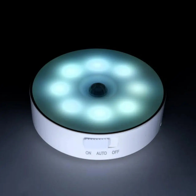 Round LED light with multiple small lights on a dark background